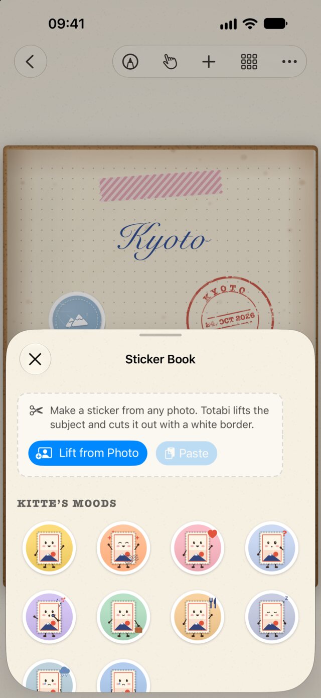 The sticker book open over a journal